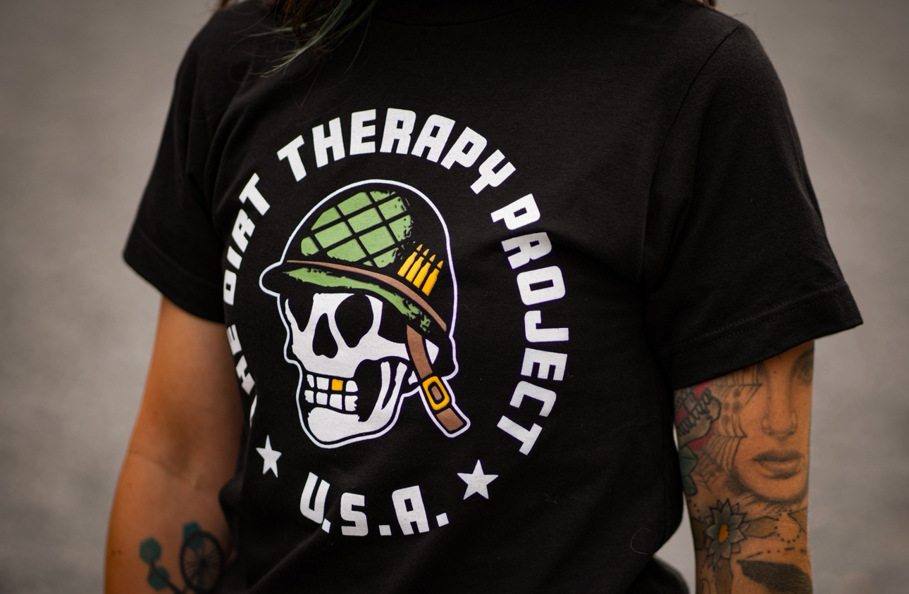 Black t-shirt with 'The Dirt Therapy Project U.S.A.' design featuring a skull and helmet on a gray background.
