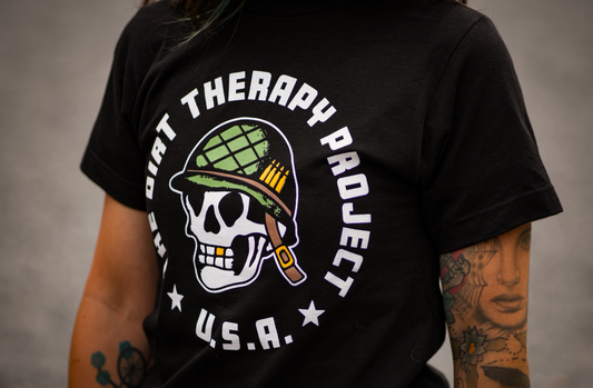 Black t-shirt with 'The Dirt Therapy Project U.S.A.' design featuring a skull and helmet on a gray background.